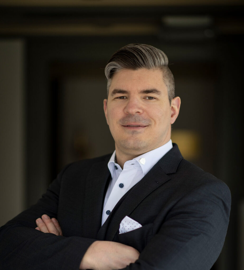 a man in a suit with his arms crossed